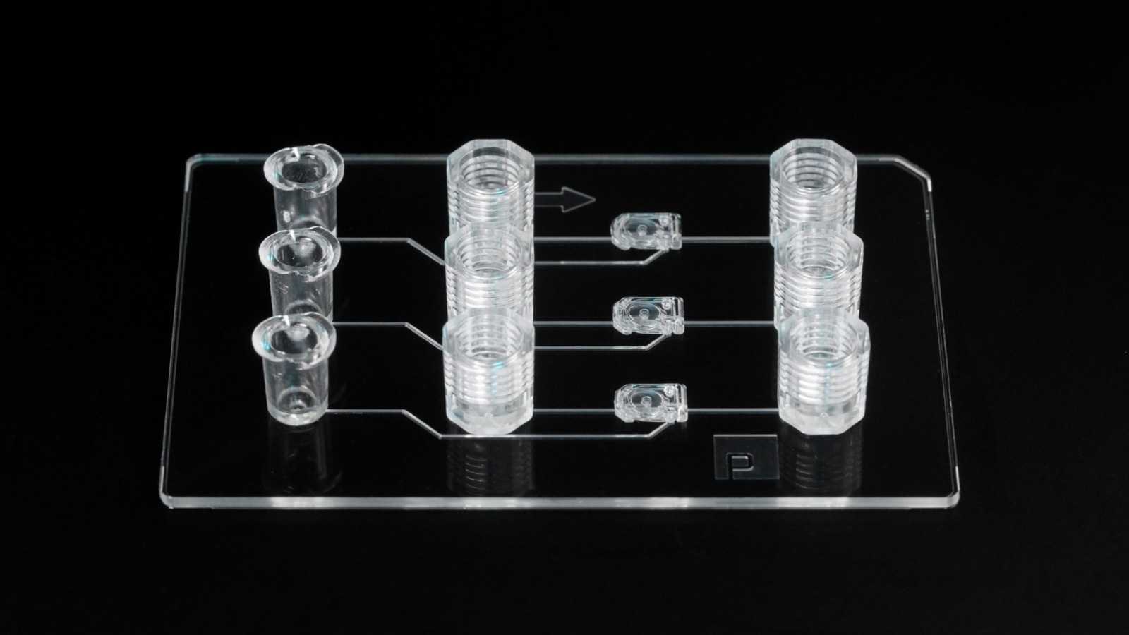 A double-slide format microfluidic device with three lure-lock ports, three MV-2 microvalves, and six 1/4-28 ports.