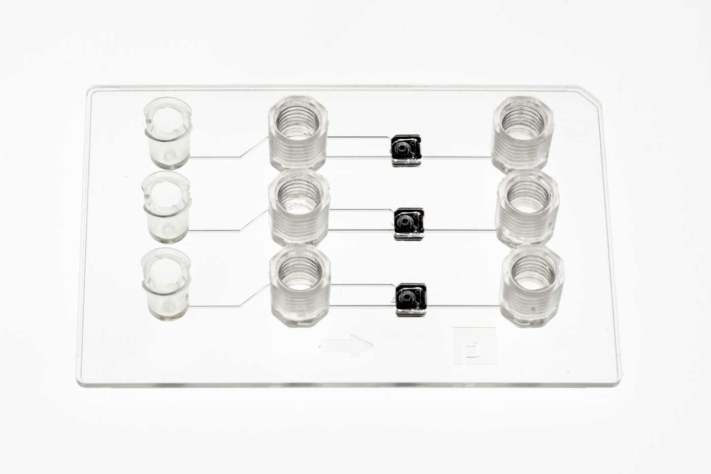 A double-slide format microfluidic device with three MV-1 microvavles on top of a white background.