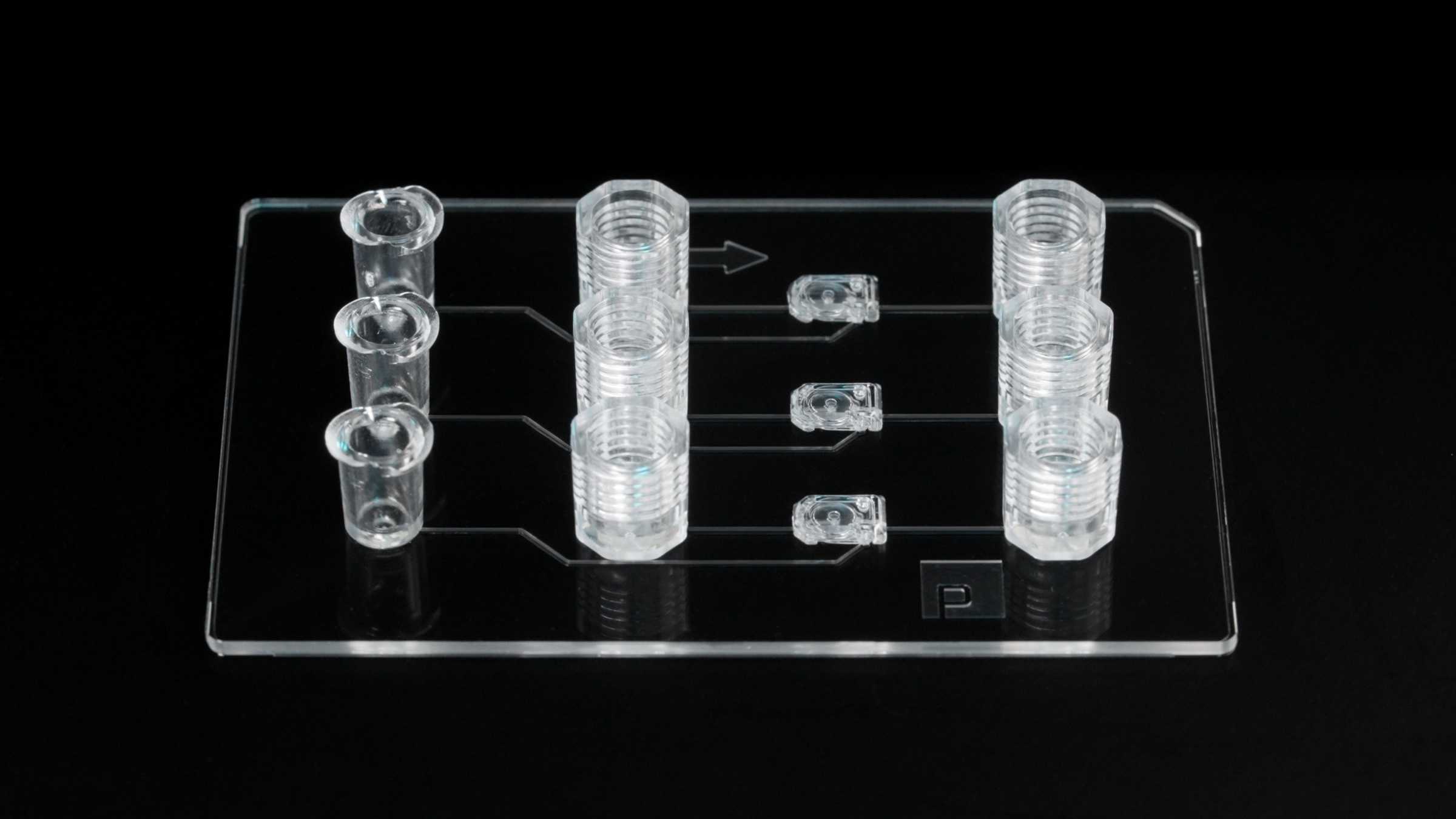 A microfluidic device with animated lines flowing through its air and fluidic channels.