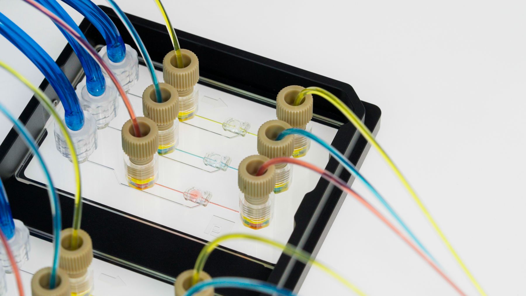 Fluidic tubing and airlines coming out of a microfluidic device.
