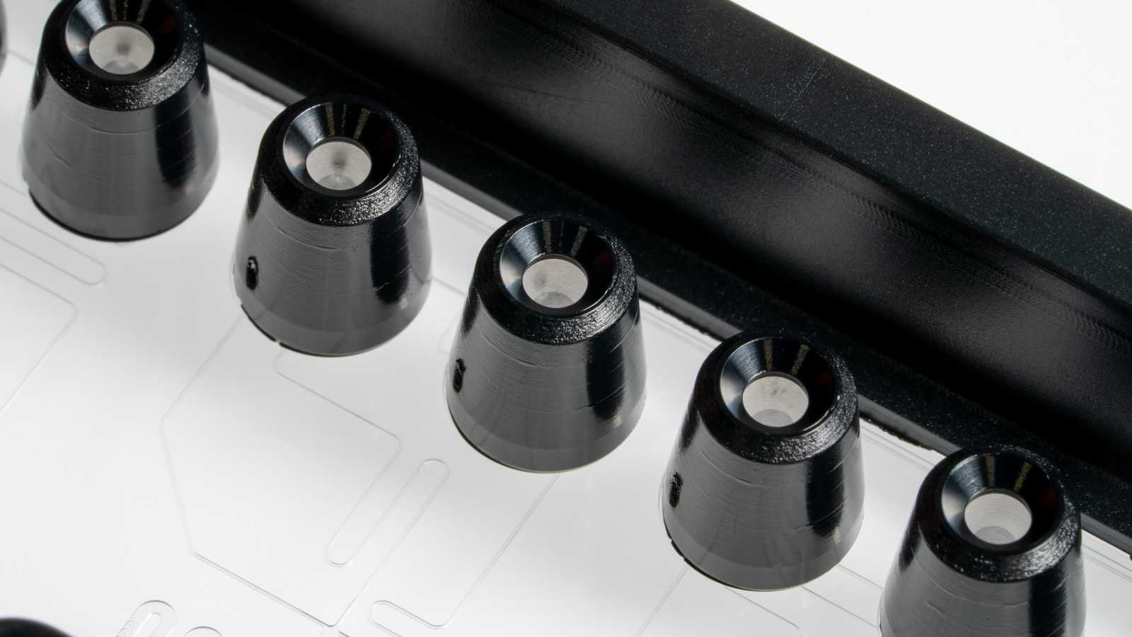 Close-up of a pipette interface on a SLAS format microfluidics device. The pipette interface is of a tapered conical shape, and has an opening at the top.