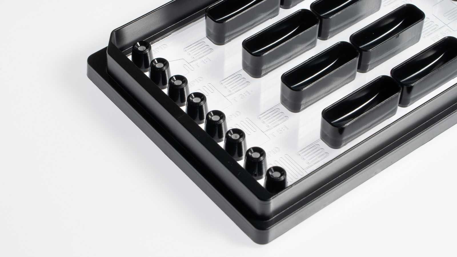 A row of eight pipette interfaces at one edge of a SLAS format microfluidic device.