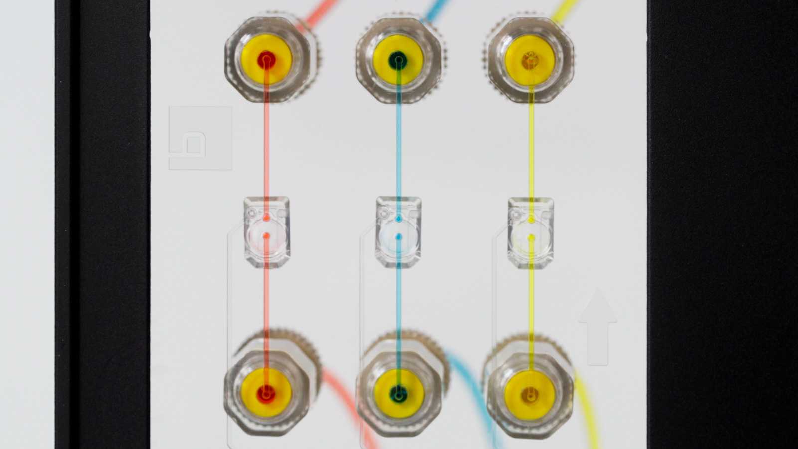 Three MV-2 microvalves mounted on a microfluidic device, connected to six 1/4-28 ports.